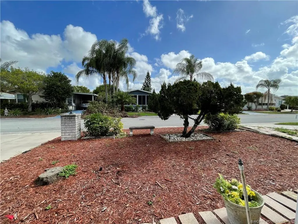 Professionally landscaped front yard. at 16300 SW Indianwood Circle, Indiantown