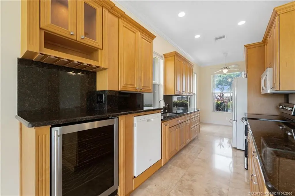 Kitchen with built in wine refrigerator at 2018 SW Mayflower Drive, Palm City