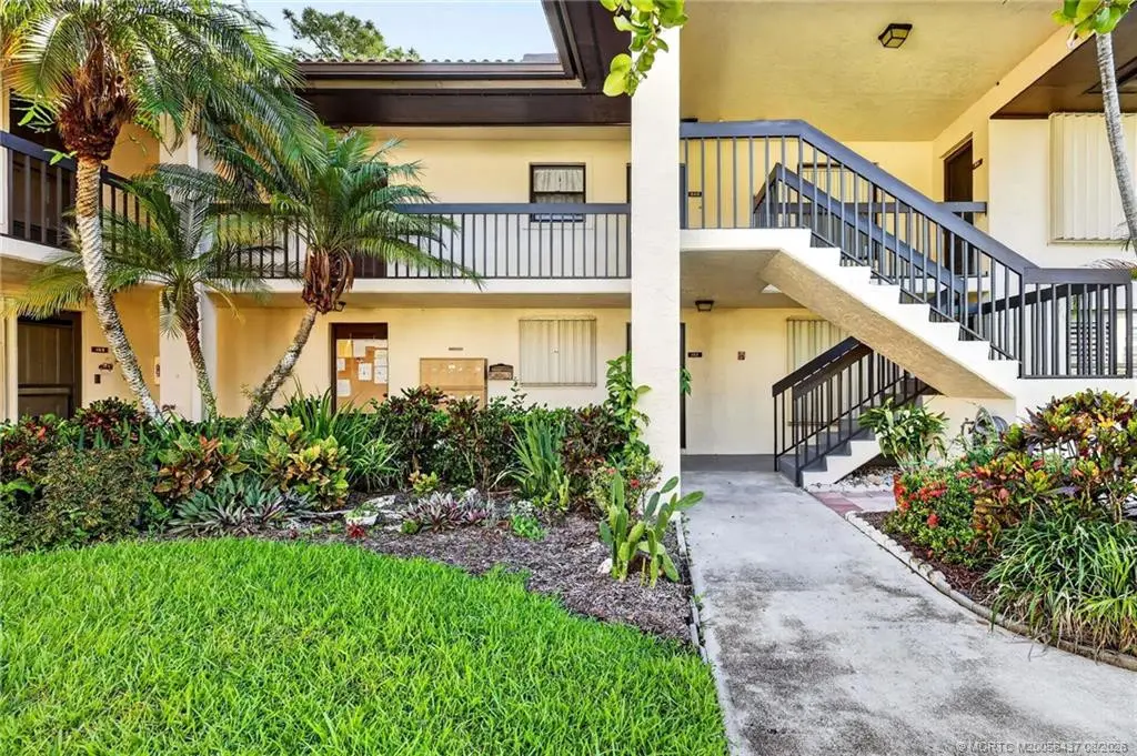 Stairs with a landing to #203 at 211 SW South River Drive 203, Stuart