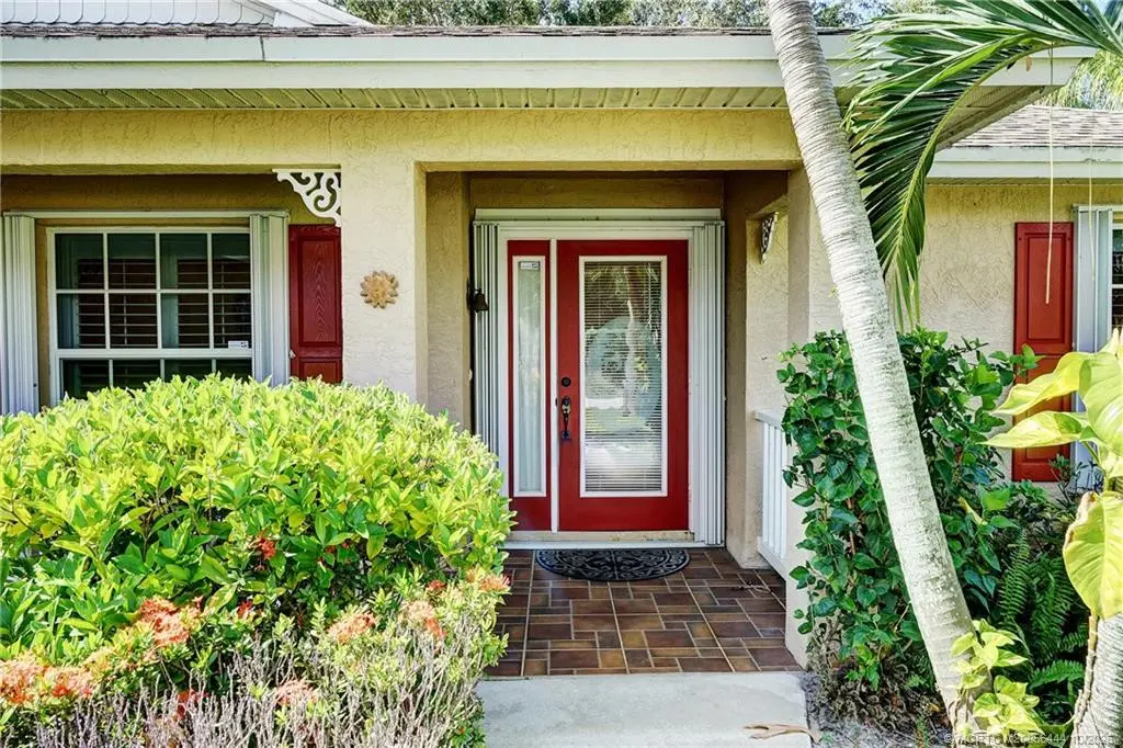 Front door with covered patio at 446 NE Vanda Terrado, Jensen Beach