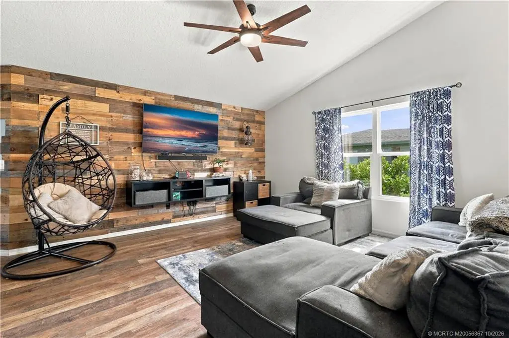 Living room featuring wood accent wall at 2134 SE Gaslight Street, Port St. Lucie