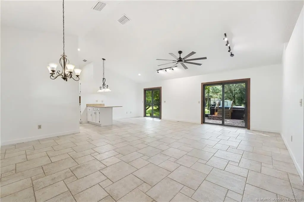 Great room with two impact sliders. at 5820 SW Grove Street, Palm City