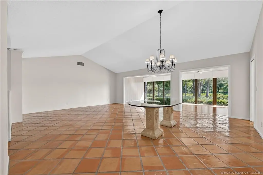 Living room with dining area at 2115 NW Greenbriar Lane, Palm City