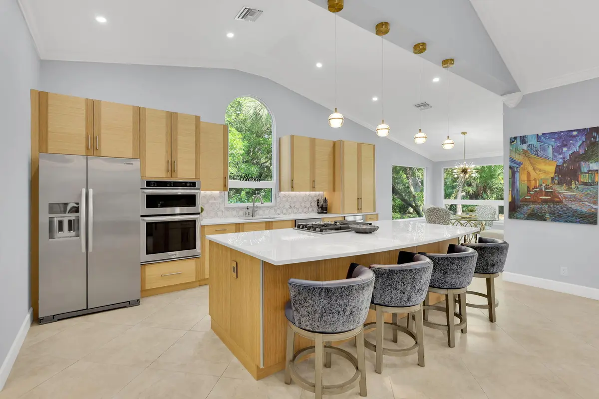 Opened with view of tropical side yard at 12831 NW Cinnamon Way, Palm City