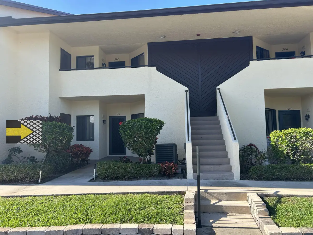 Williamsburg 103 Buiding Front with arro at 6820 SE Constitution Boulevard 103, Hobe Sound