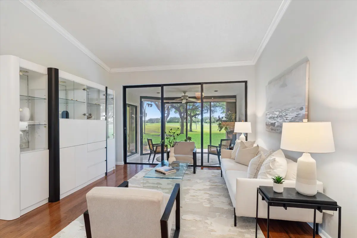 Living Room/View to Enclosed Sunroom at 5272 Fairway Woods Drive 4113, Delray Beach