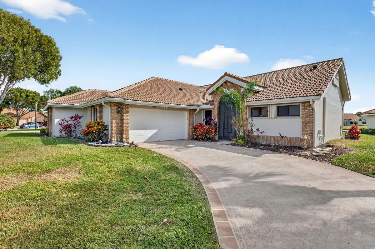 long driveway exterior front at 7400 Hearth Stone Avenue, Boynton Beach