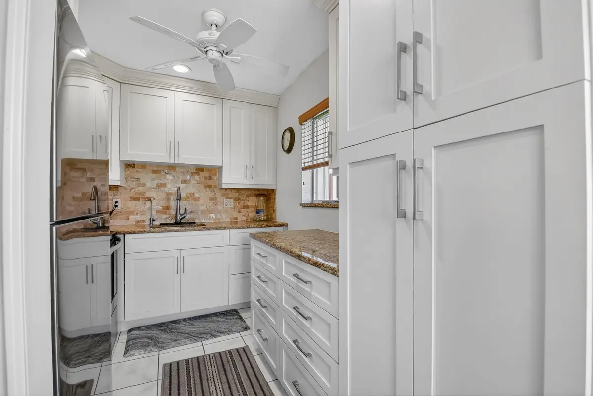 high end custom kitchen with large pantr at 3320 Lake Osborne Drive 102, Lake Worth Beach