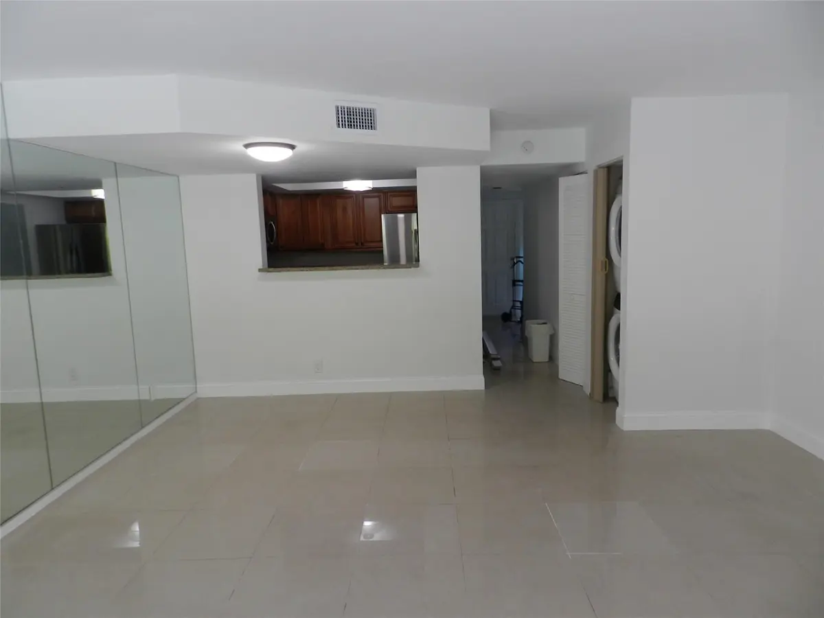 Living Room Facing Kitchen Pass-through at 73 Deer Creek Road 103, Deerfield Beach