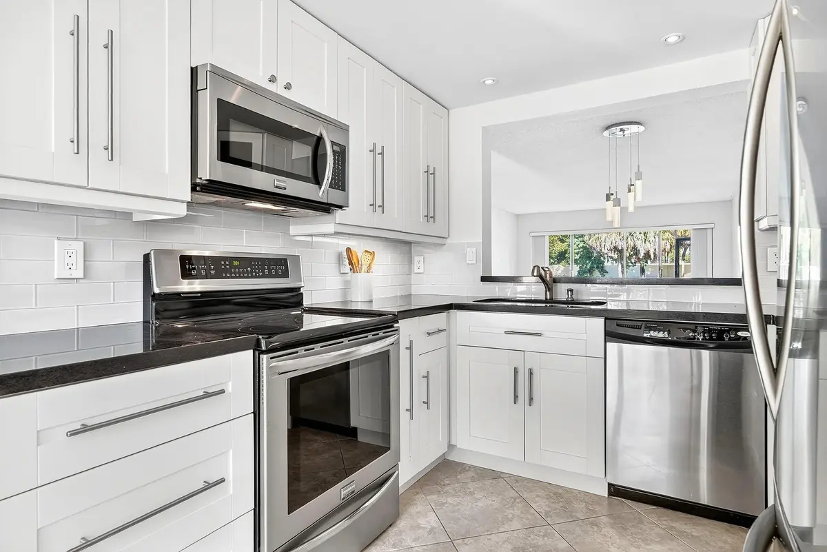 Renovated kitchen w/task lighting at 5021 Oak Hill Lane 115, Delray Beach