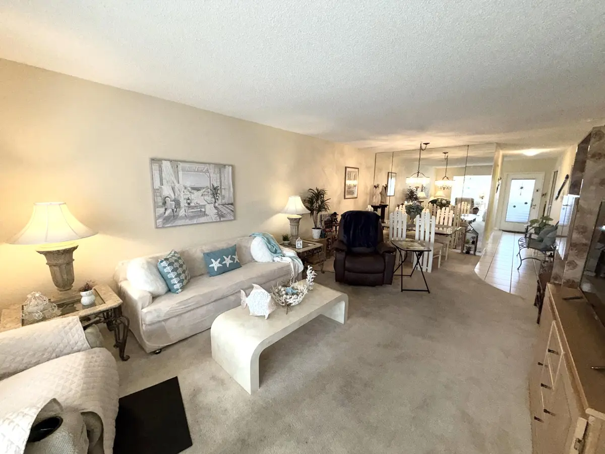 Living room to dining area at 1030 Silk Oak Terrace 101, Delray Beach