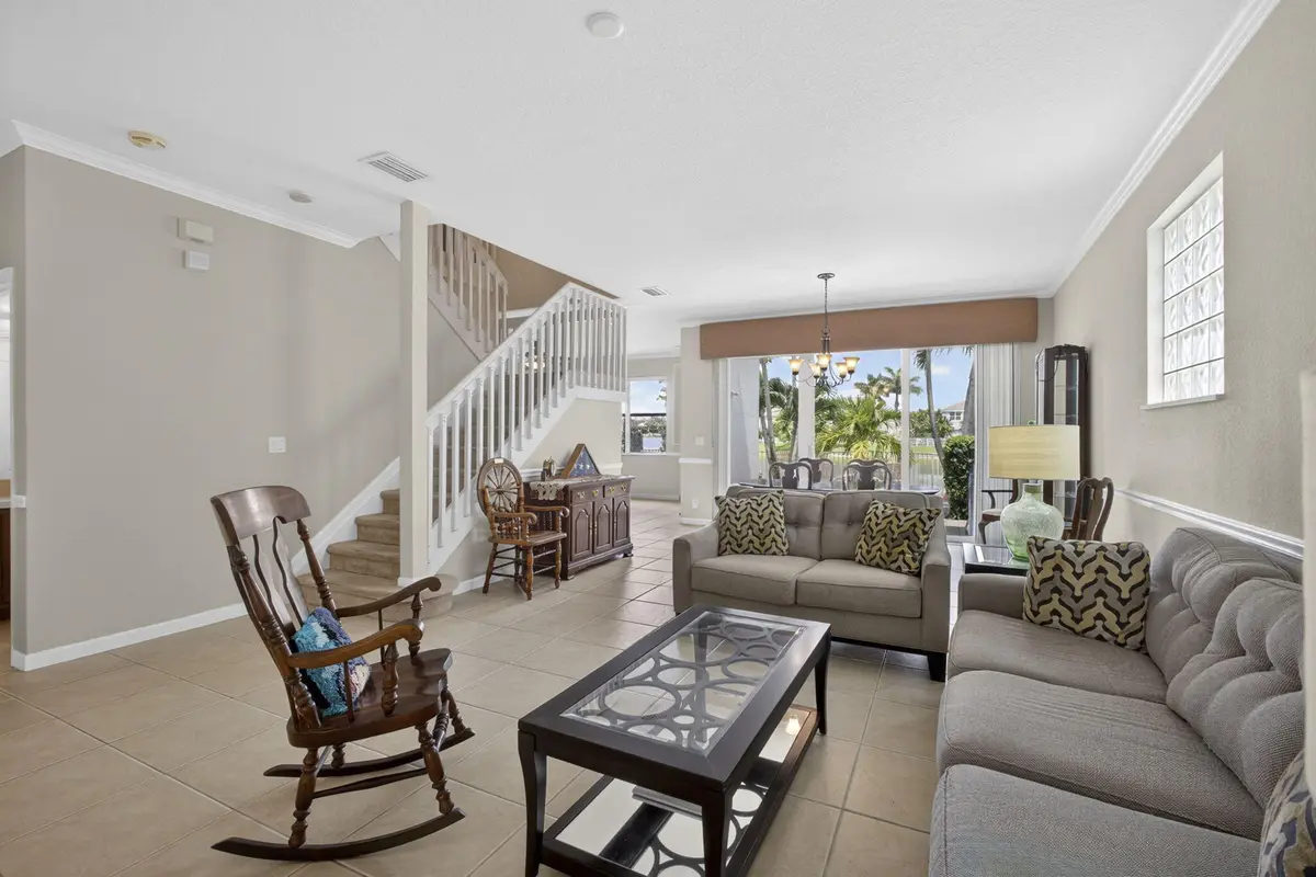 Living room with lake views at 214 Berenger Walk, Royal Palm Beach