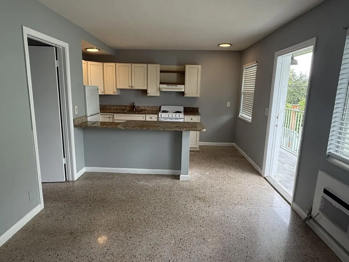 Living room and kitchen at 1118 N H Street 15, Lake Worth Beach