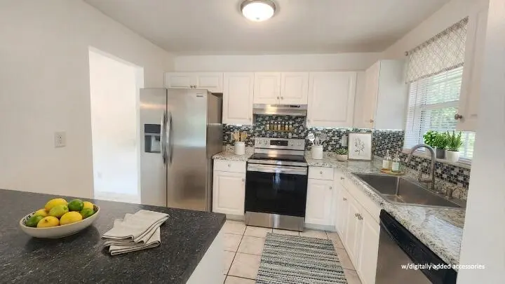 Kitchen virtual staged at 517 Dotterel Road 31c, Delray Beach