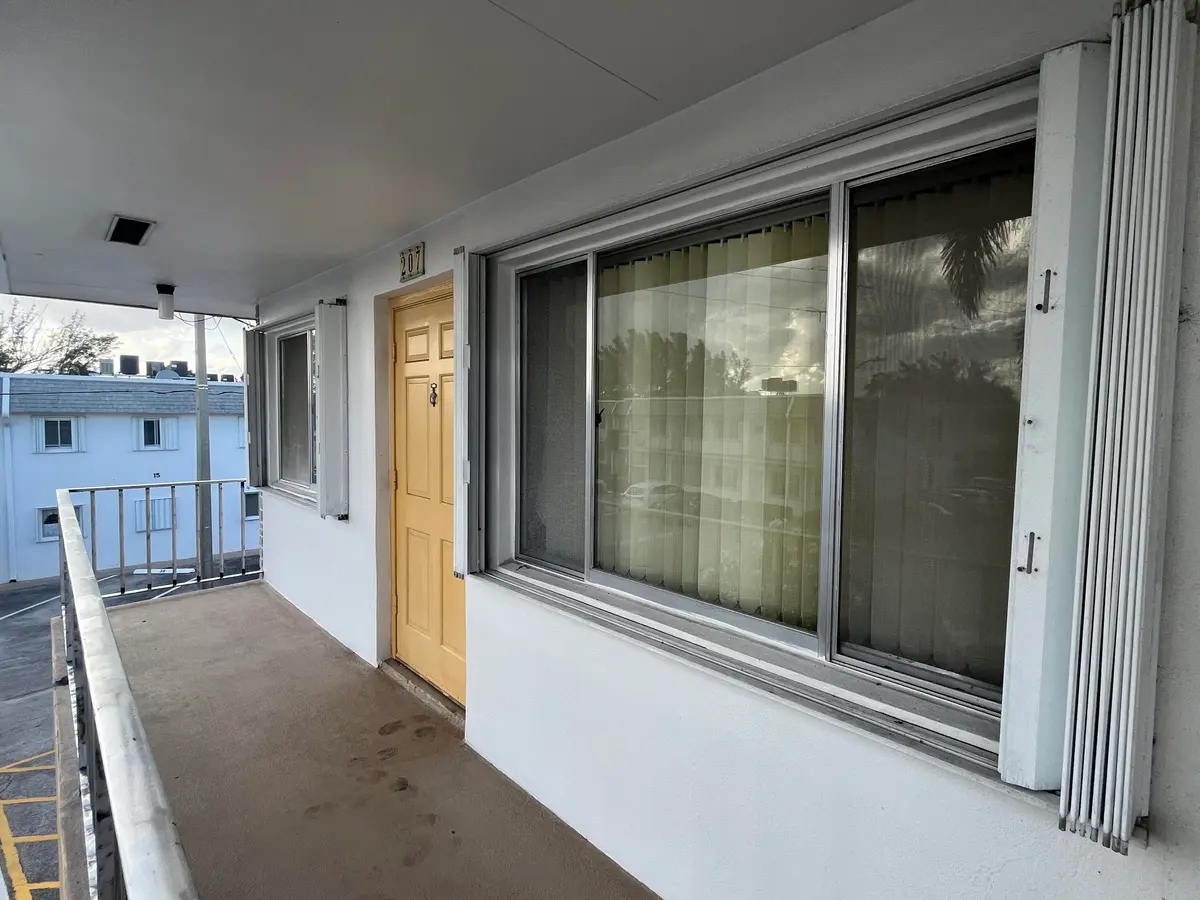 Corner unit with accordion shutters at 2840 Cynthia Lane 207, Lake Worth Beach