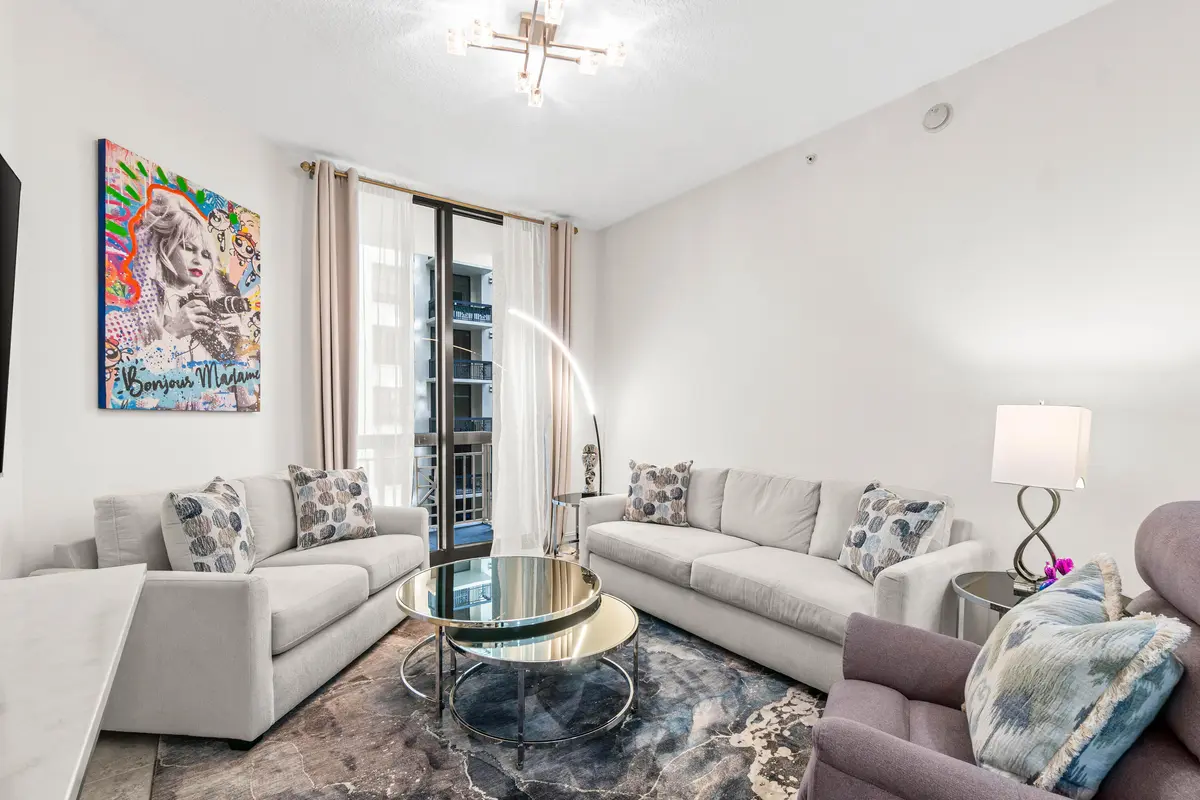 Living Room w/ Balcony Access at 701 S Olive Avenue 807, West Palm Beach