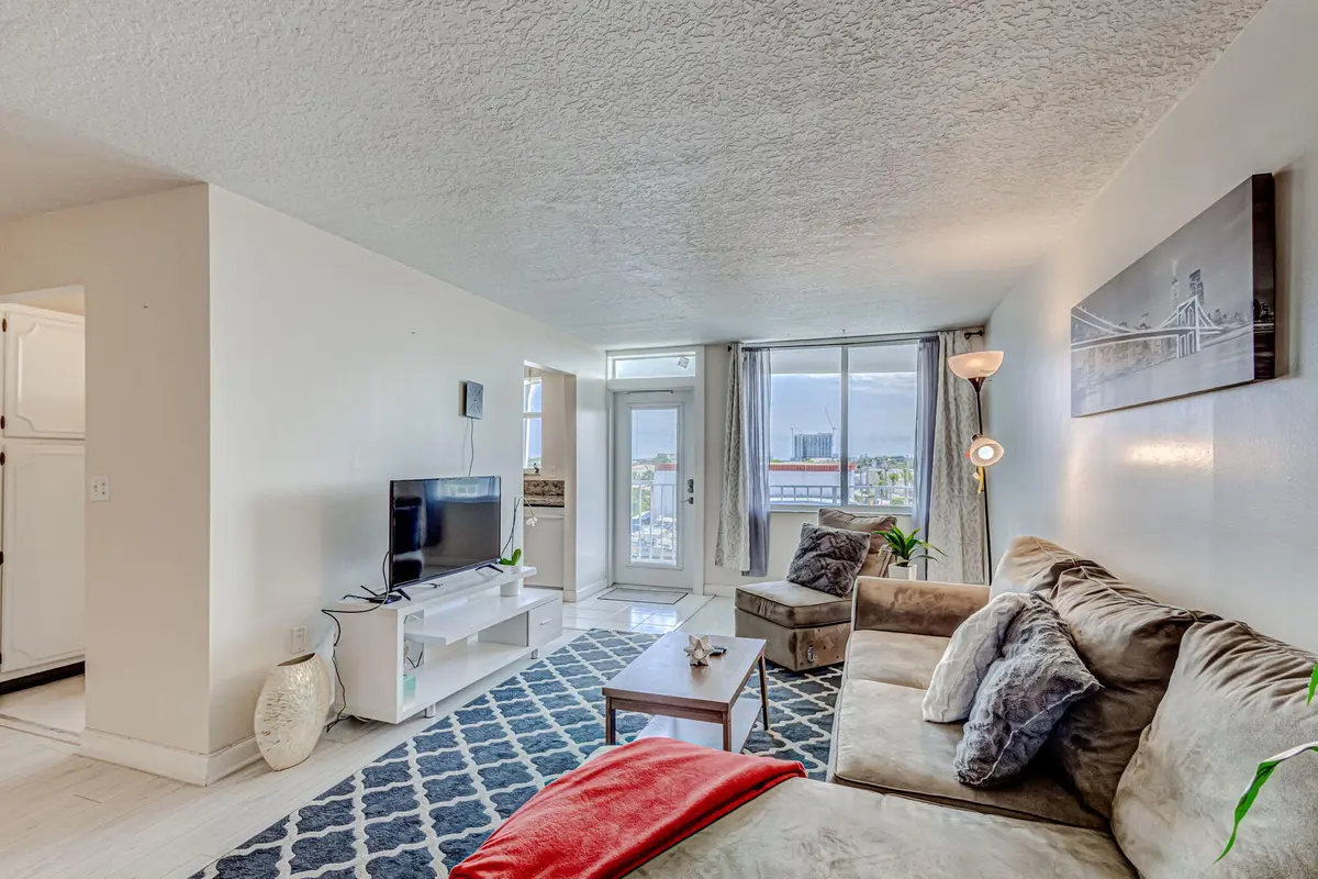 Living room facing window at 108 Paradise Harbour Boulevard 512, North Palm Beach