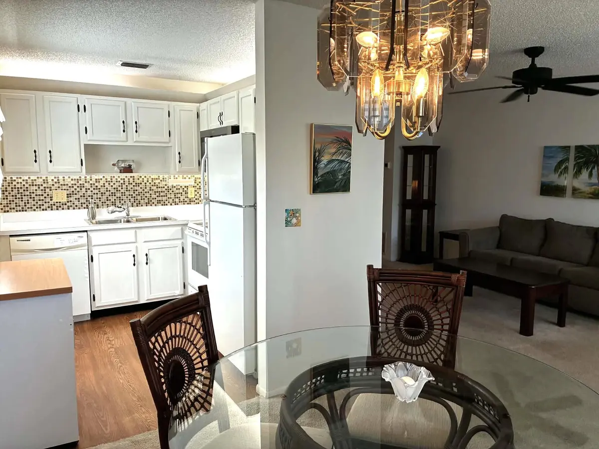 Dining to Kitchen to Living Room at 52 Woodland Drive 103, Vero Beach