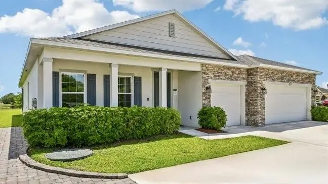 Wilmington A with 3 Car Garage side view at 717 CAVERN Terrace, Sebastian