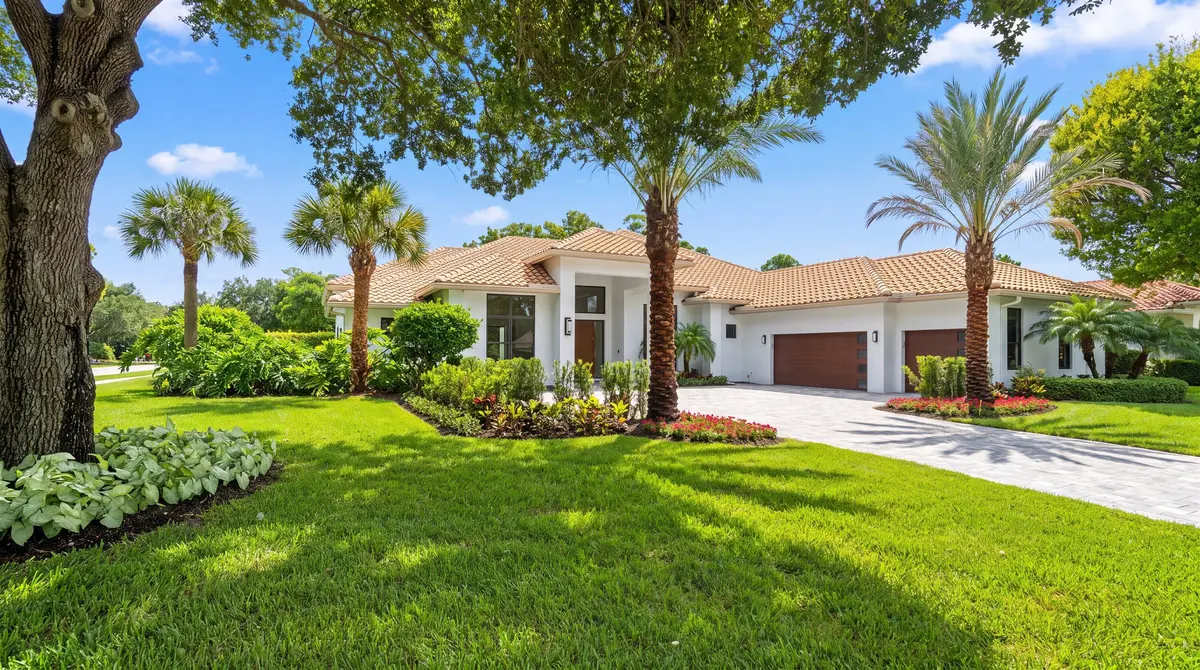 Front view and side yard at 1712 Mayacoo Lakes Boulevard, West Palm Beach