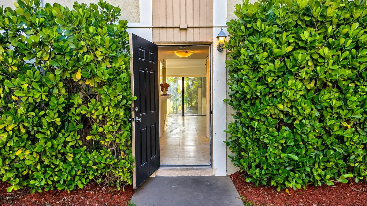 Bright Entryway Framed by Greenery at 8801 W Sample Road 4, Coral Springs
