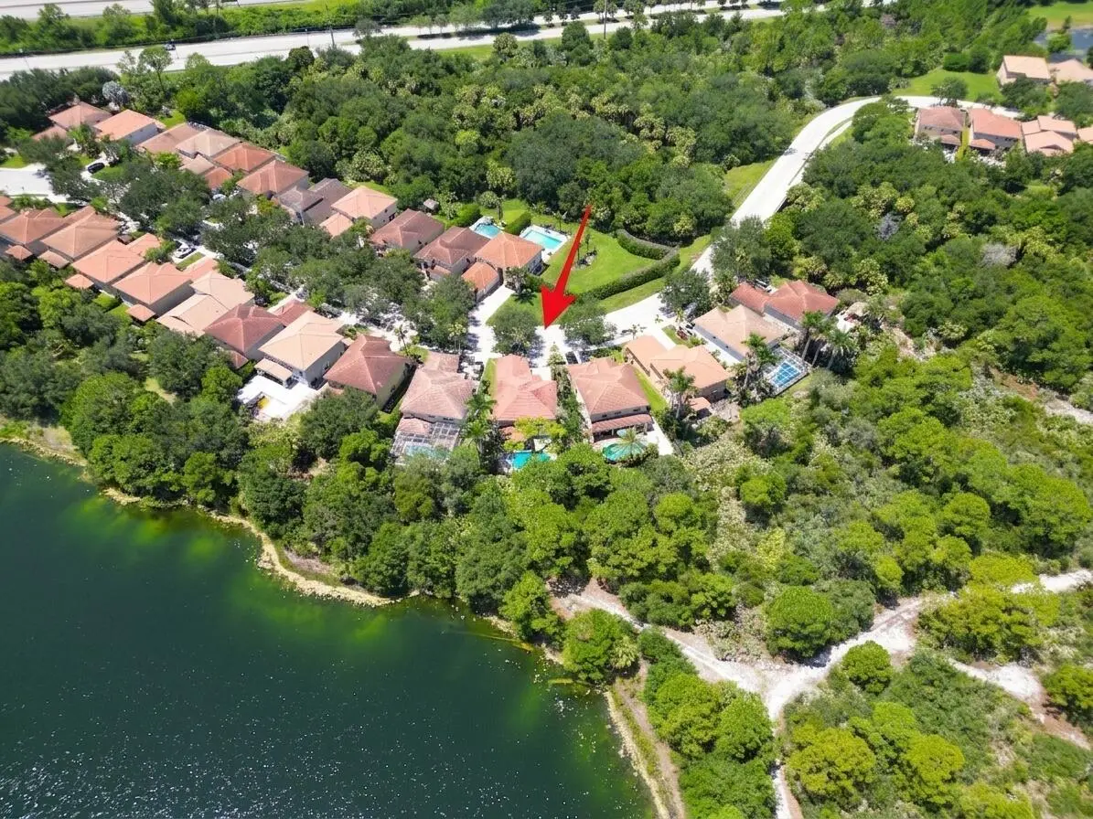 Back aerial red arrow with lake at 6181 SW Bald Eagle Drive, Palm City
