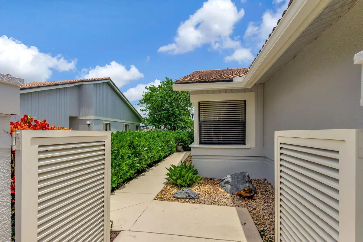 Walkway to the front door at 523 Prestwick Circle, Palm Beach Gardens