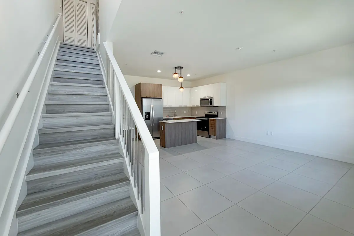 7 Staircase Overlooking Open Floorplan at 405 NE 35TH Court 2, Oakland Park