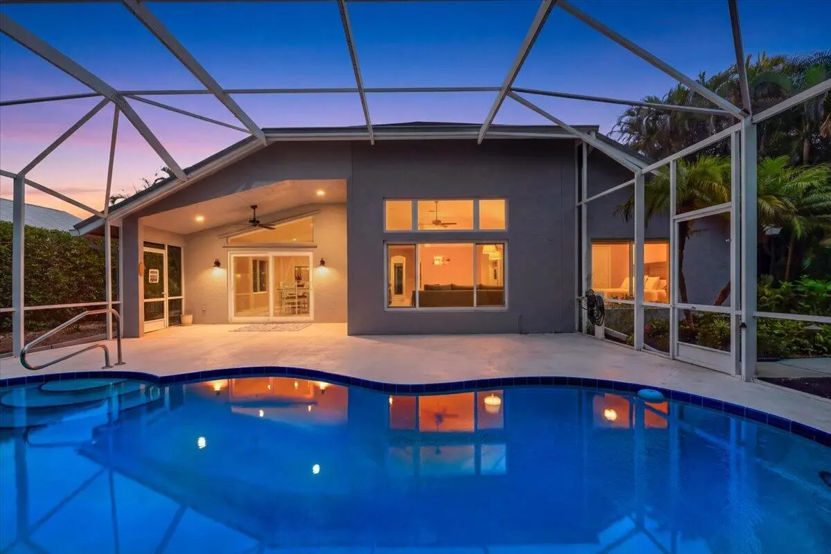 7990 SE Mammoth Dr pic pool twilight at 7990 SE Mammoth Drive, Hobe Sound