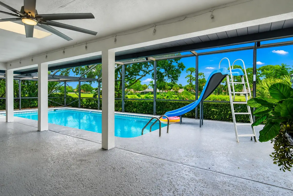 covered lanai with pool and canal view at 1157 SW Mirror Lake Cove, Port St. Lucie