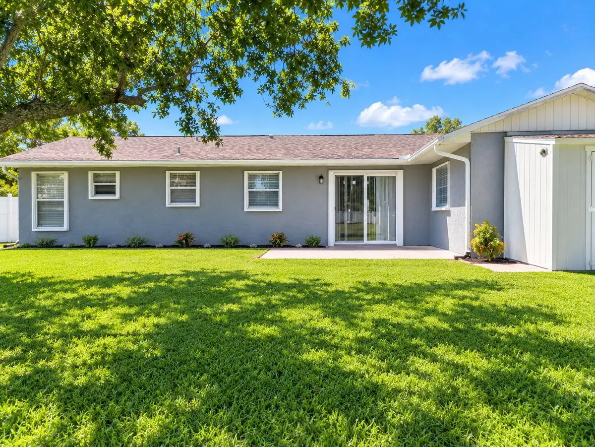 Back of home with patio and storage shed at 7402 LAKELAND Boulevard, Fort Pierce