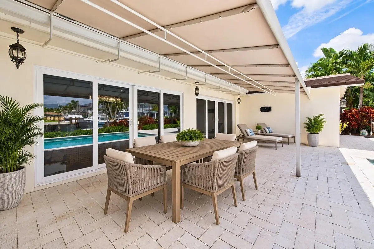 Stage back patio with table at 2401 NE 47TH Street, Lighthouse Point
