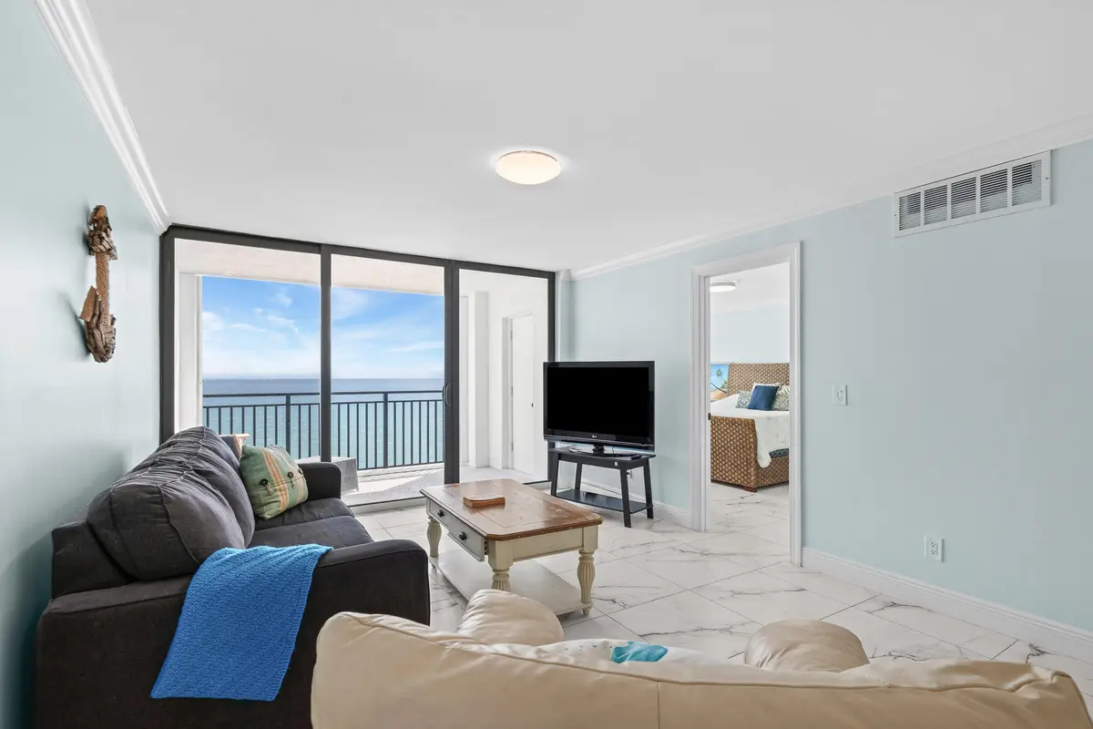 Living room w/ balcony at 10102 S Ocean Drive 705A, Jensen Beach