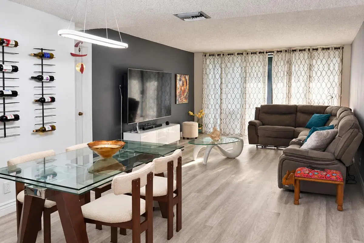 dining and living room at 16500 Golf Club Road 301, Weston