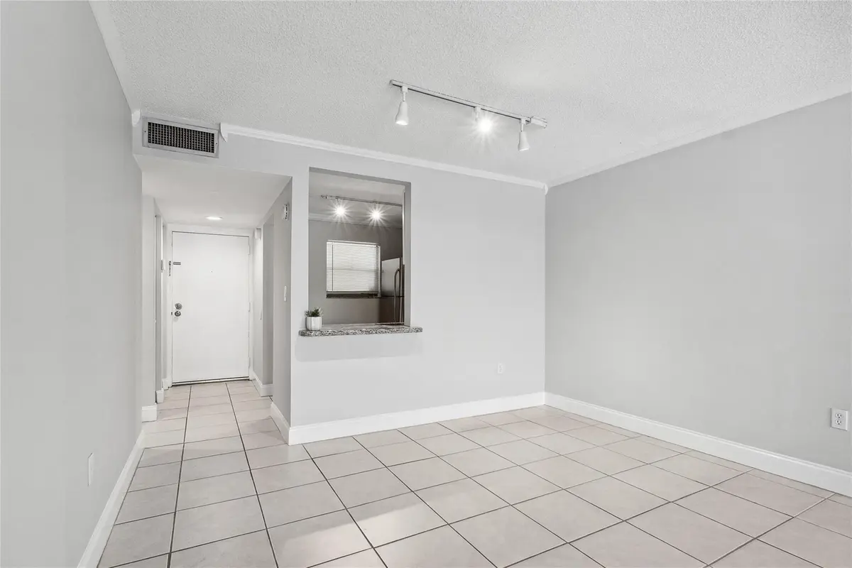 Dining area open to kitchen at 485 N Pine Island Road 105A, Plantation