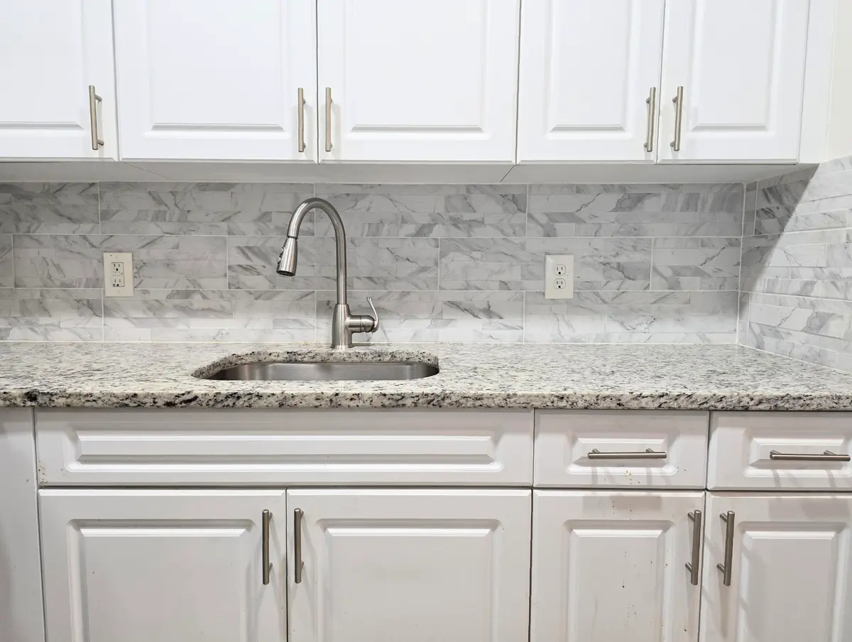 White cabinets with Stone backsplash at 204 CANTERBURY I, West Palm Beach