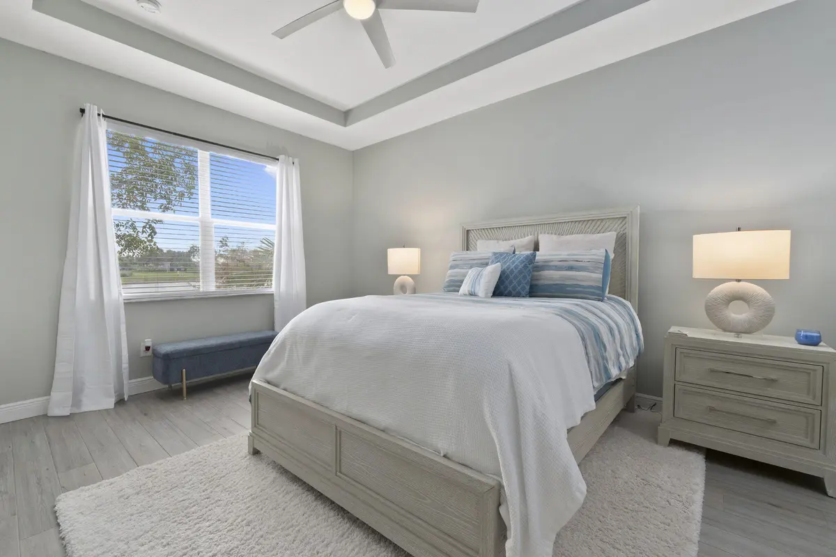 Master bedroom with coffered ceiling at 10971 SW DUNHILL Court, Port St. Lucie