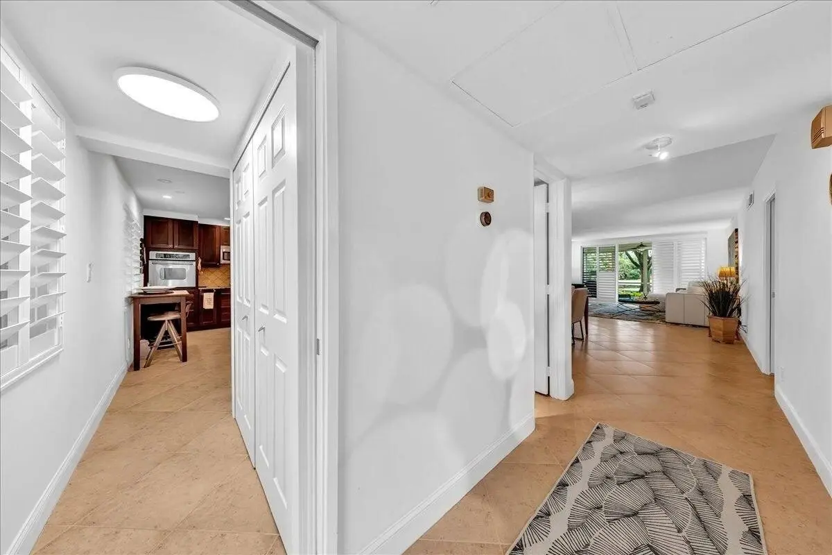 View of laundry closet, foyer, and liv at 3505 Oaks Way 109, Pompano Beach