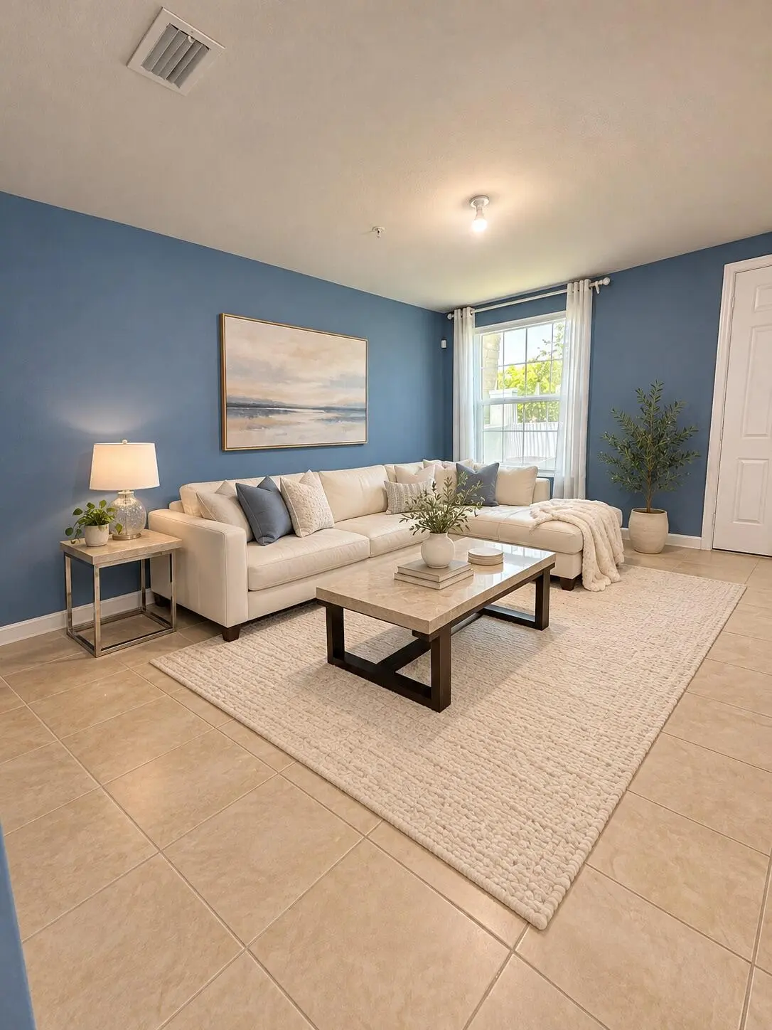 Elegantly staged blue-walled living room at 4618 Monarch Way, Coconut Creek