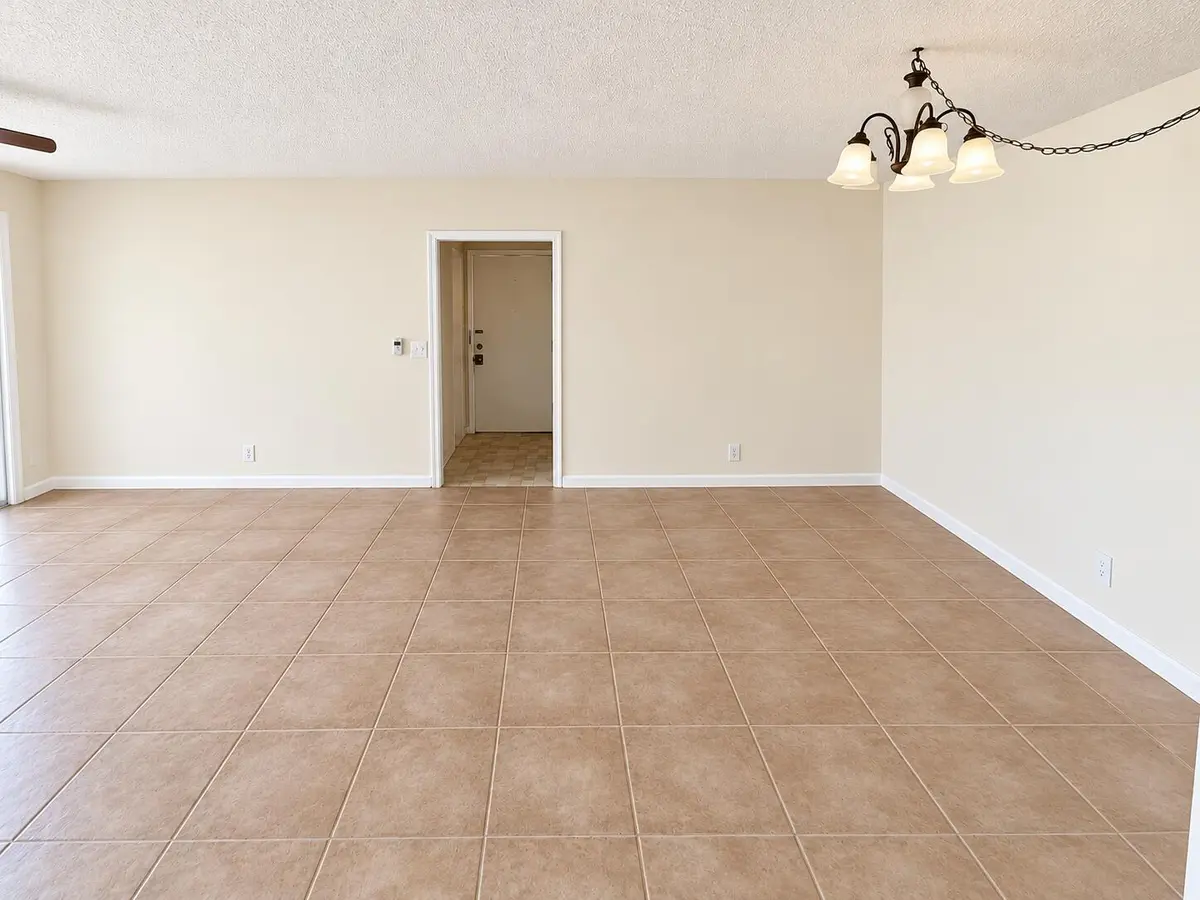 Empty Cream-Tiled Room with Chandelier at , Boca Raton