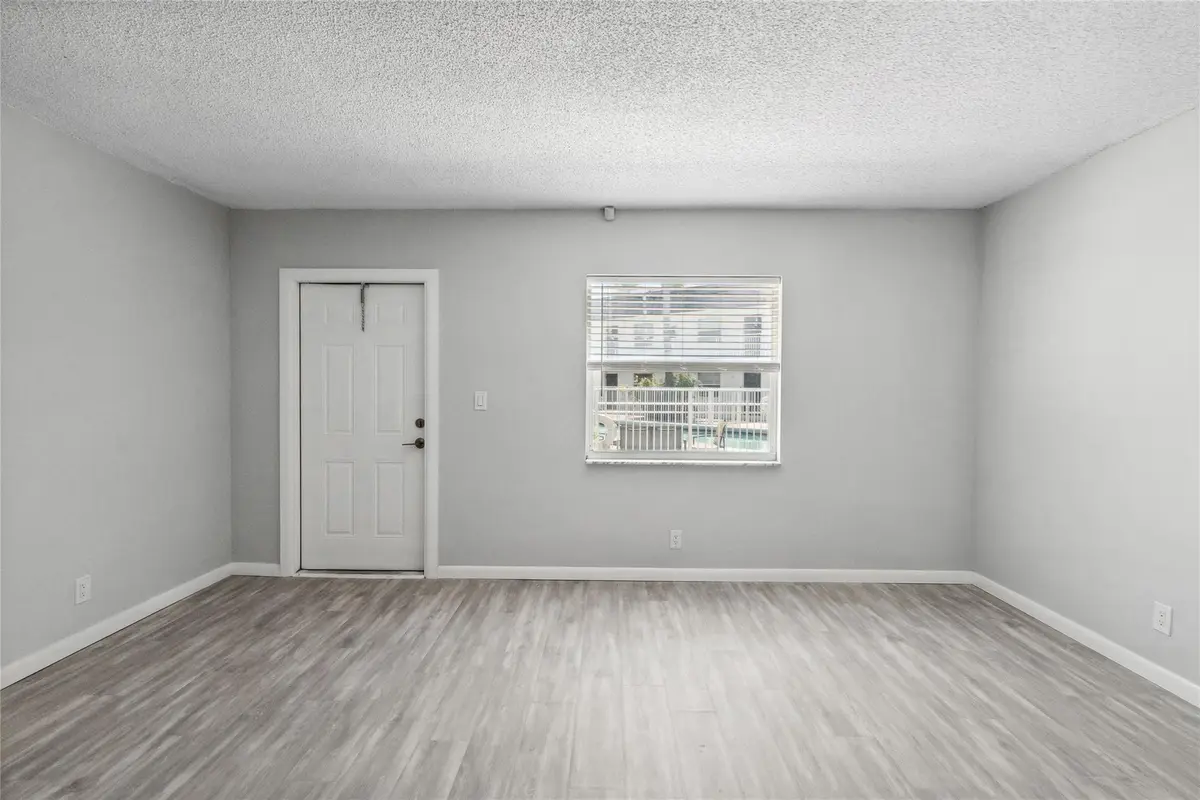 Impact window with view of pool at 1470 N DIXIE Highway 19, Fort Lauderdale