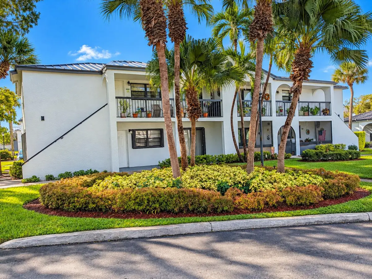 Tropical Palm-Framed Condominium Exterio at 18286 MEDITERRANEAN Boulevard 202, Hialeah