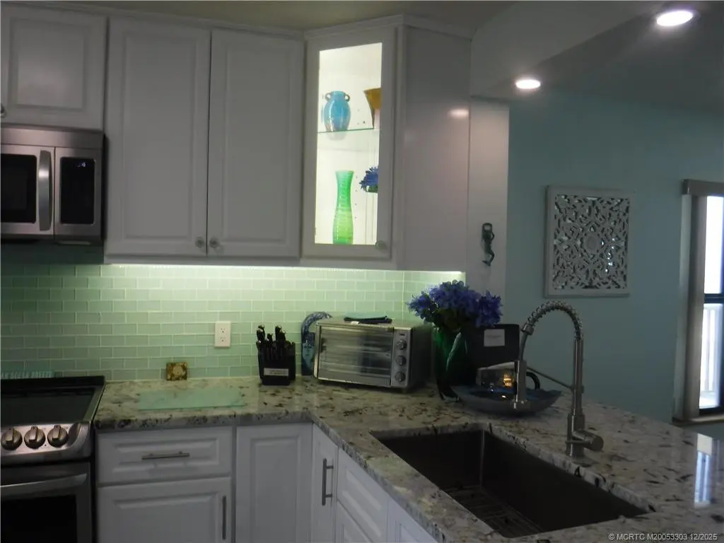 Lighted corner kitchen cabinet at 7380 S Ocean Drive 517, Jensen Beach