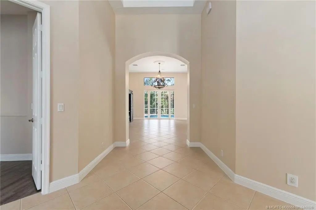 Entrance hall to living area at 511 SW Squire Johns Lane, Palm City