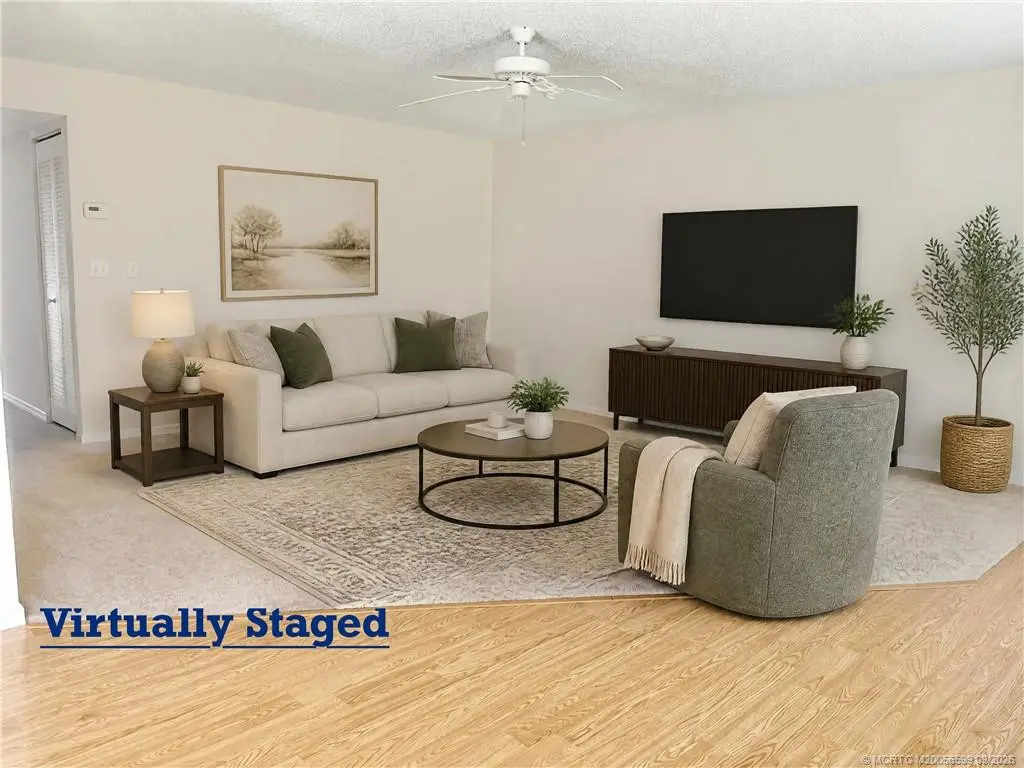 Living area with staging at 911 SW South River Drive 107, Stuart