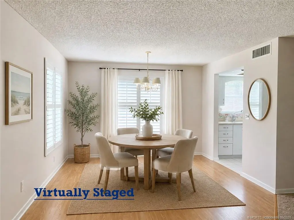 Dining area with staging at 911 SW South River Drive 107, Stuart