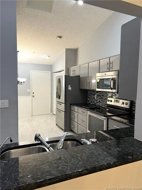 Pass thru from kitchen to dining area at 3678 SW Whispering Sound Drive, Palm City